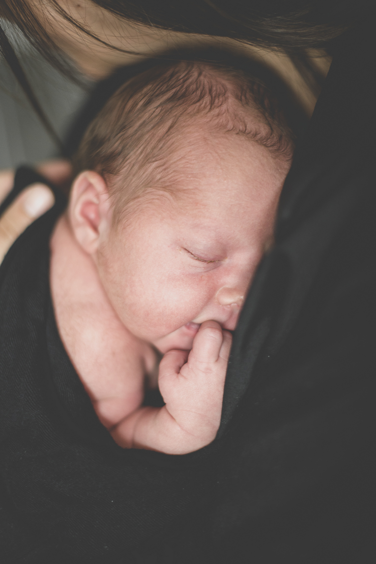 Newborn photo-shoot - newborn sleeping in the arms of his mum - Newborn Photographer