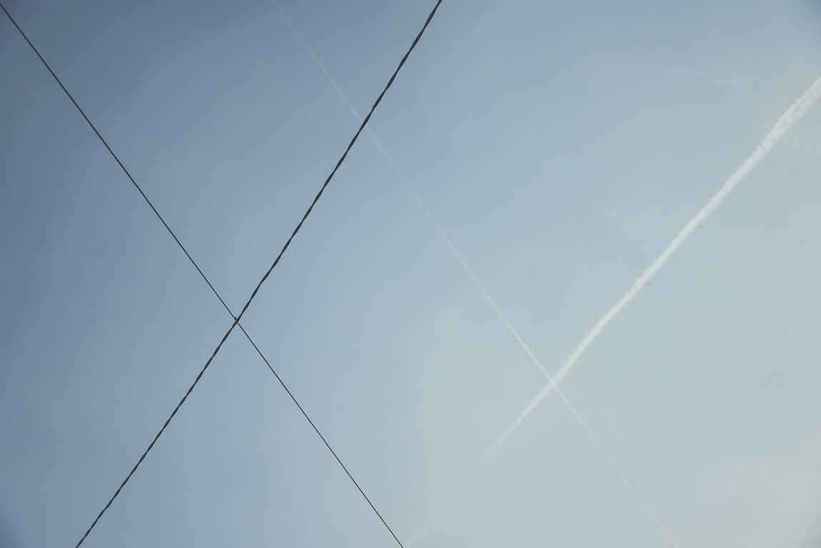 Reportage village Alan - cables électriques et traces d'avion dans le ciel - Photographe voyage