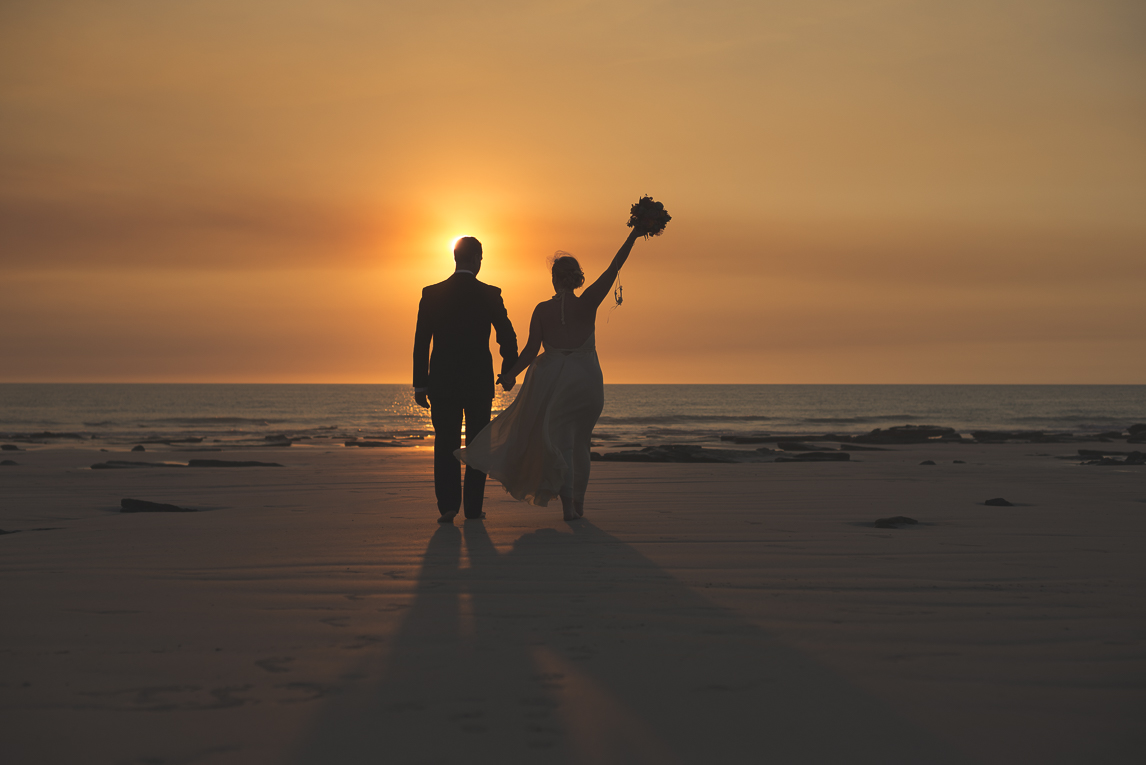 rozimages - wedding photography - bride and groom on the beach, walking towards the sea and sunset - Broome, Australia