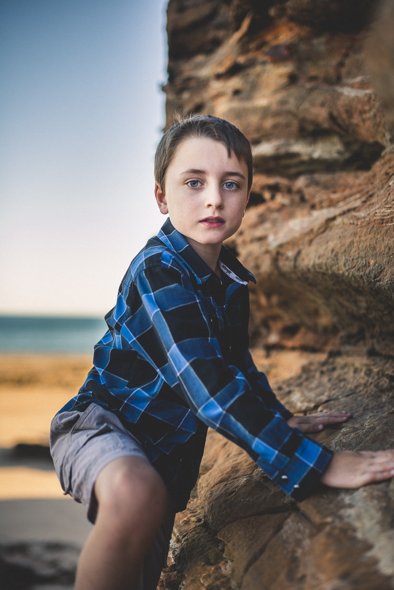 rozimages - family photography - beach session - boy climbing rock on beach - Reddell Beach, Broome, Australia