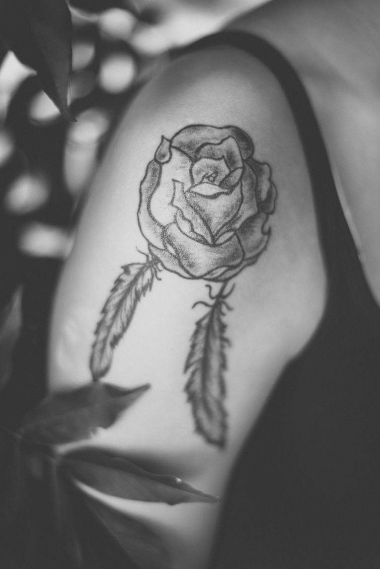 rozimages - photographie lifestyle et portraits - séance individuelle - gros plan d'un tatouage représentant une rose et deux plumes - Mondavezan, France