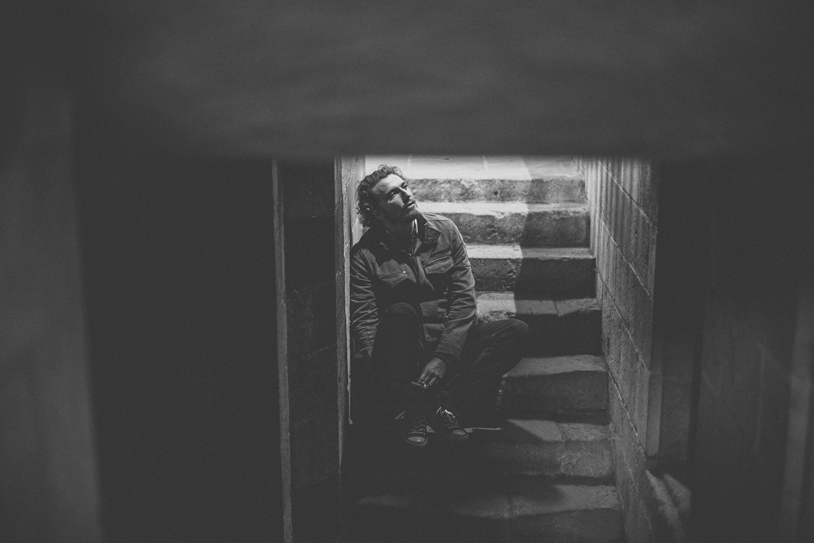 rozimages - travel photography - man sitting on steps - Foix, France