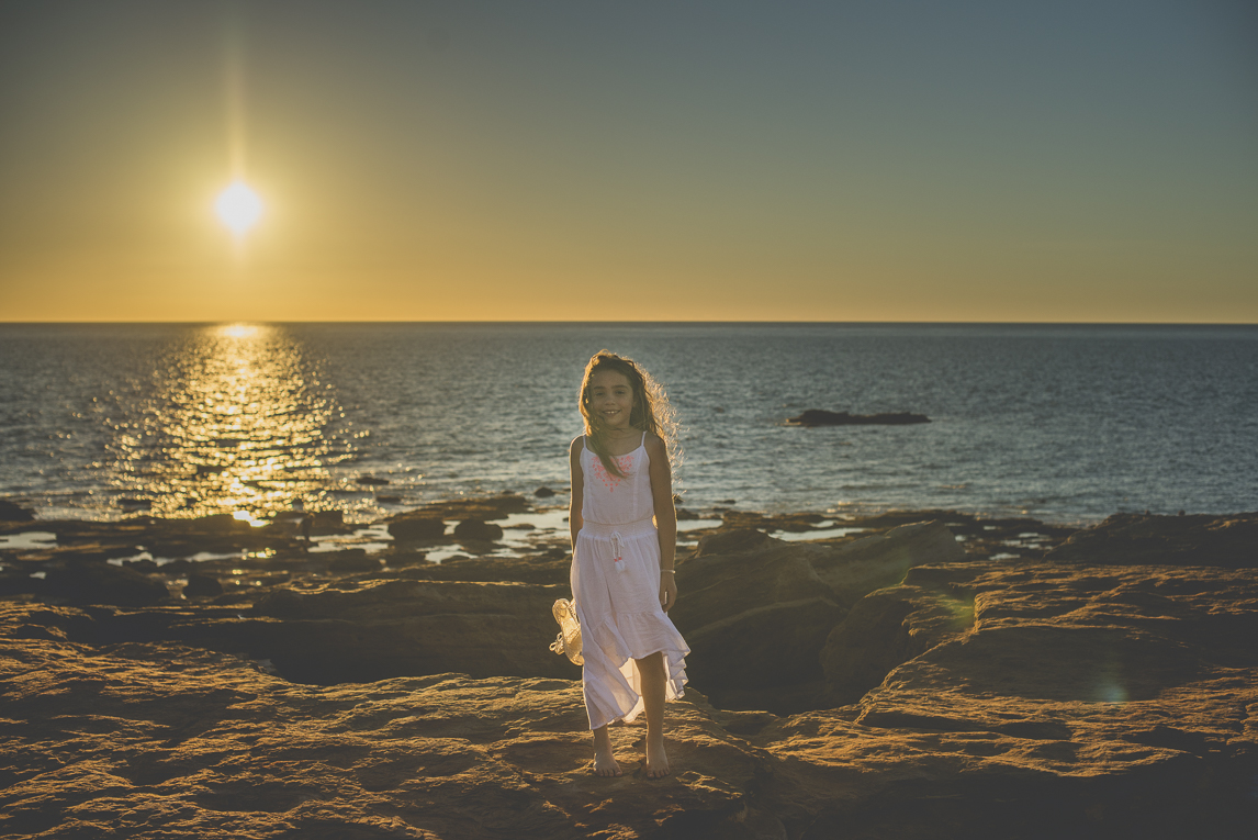 Family photo session - child on rocks in front of the sea - Family Photographer