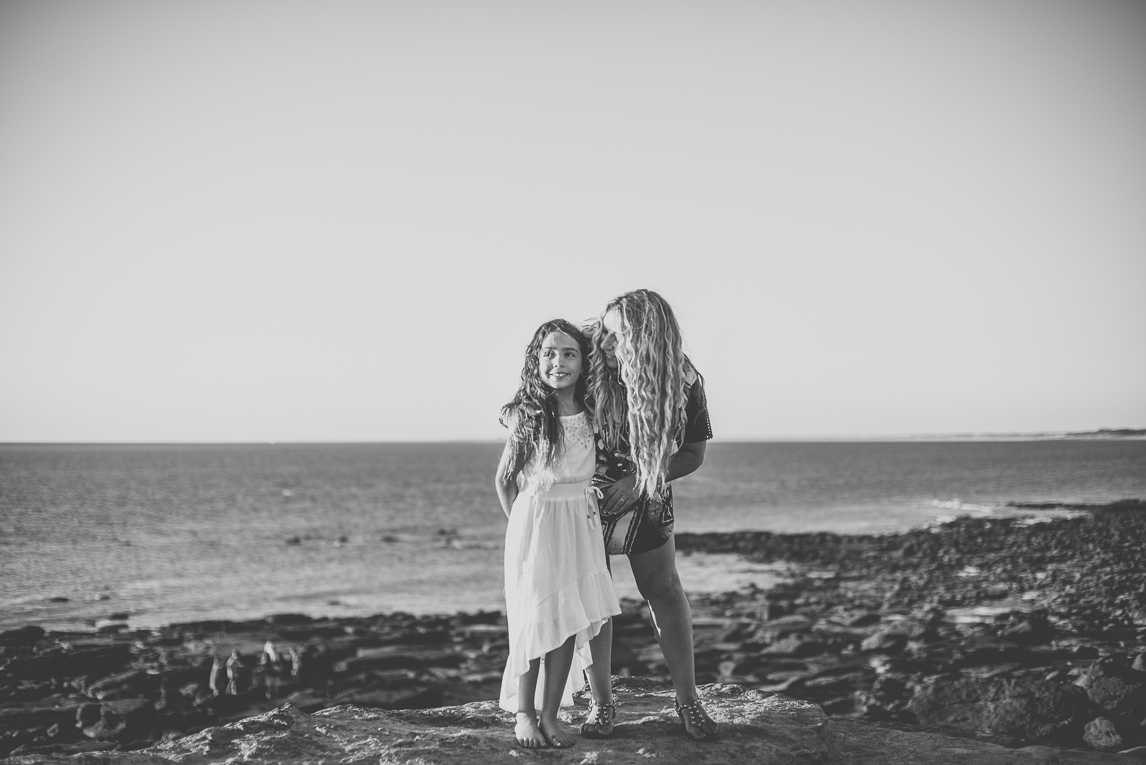 Family photo session - child and mum on rocks in front of the sea - Family Photographer