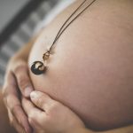 Pregnancy photo session - Bola necklace on baby bump - Pregnancy Photographer