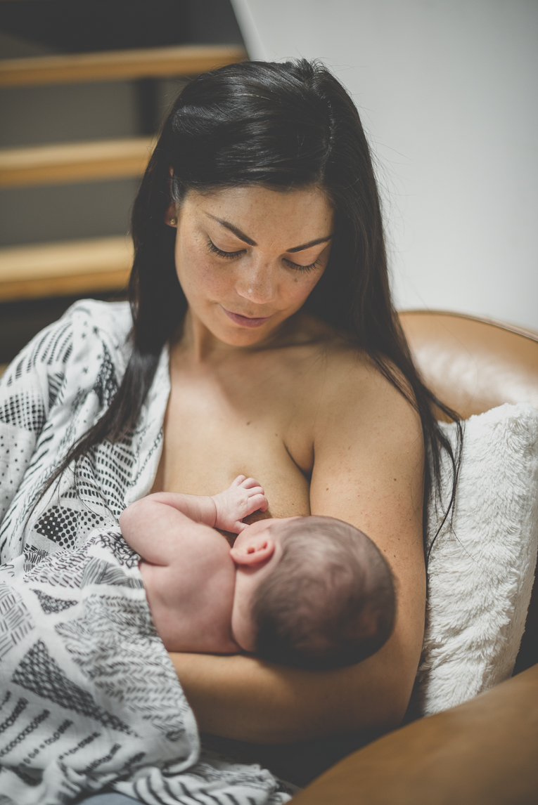 Newborn photo-shoot at home Southern France - mum breastfeeds her newborn - Newborn Photographer