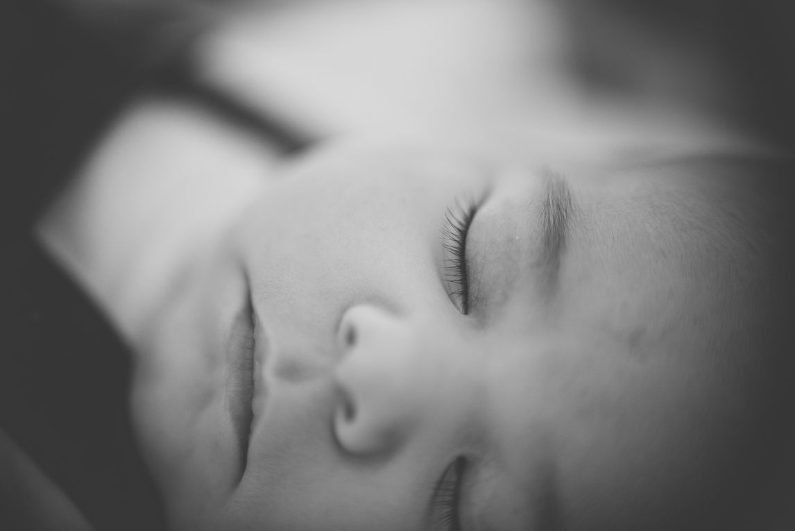 Baby photo session at home - close up on face of sleepy baby - Baby Photographer
