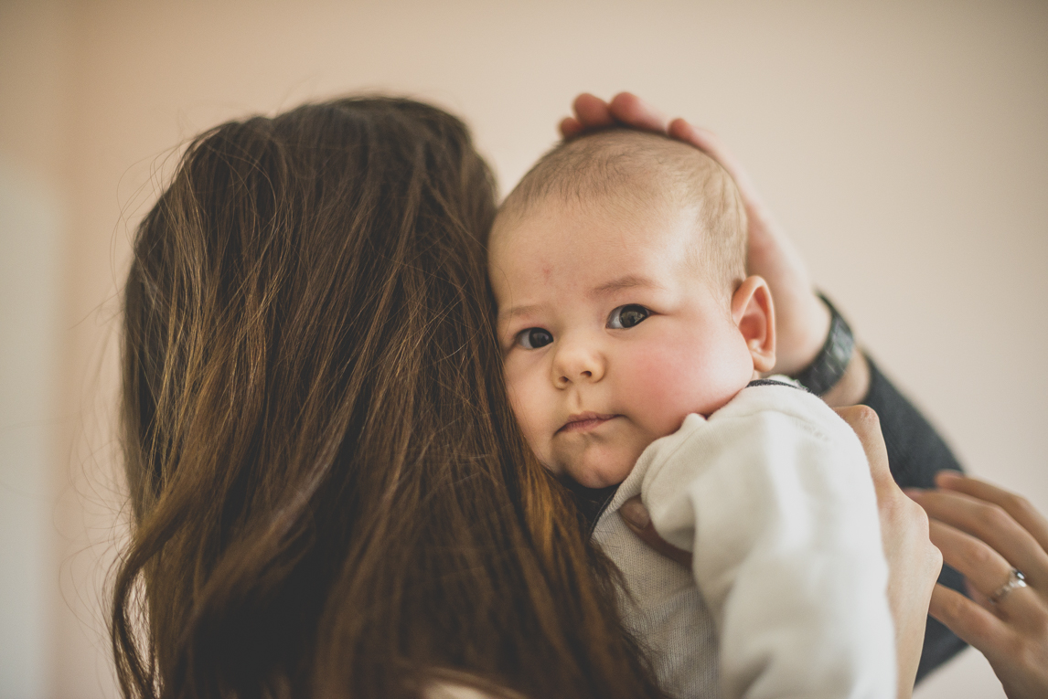 Baby photo session at home - baby in the arms of his mum - Baby Photographer