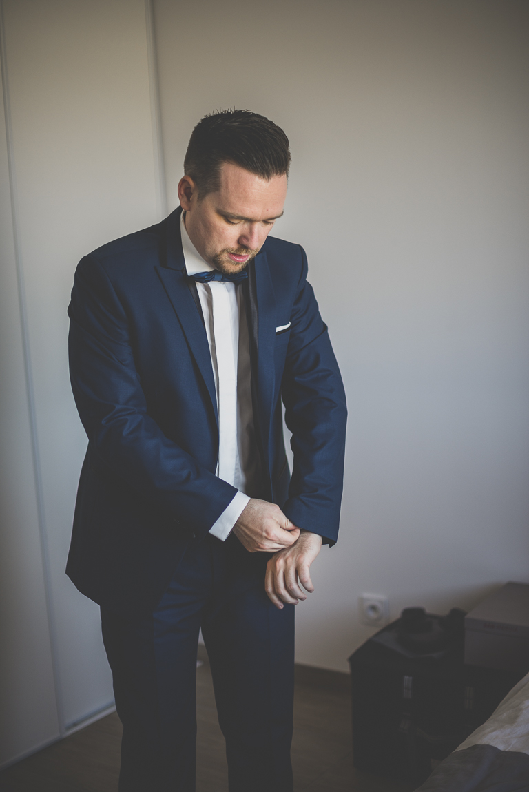 Winter Wedding Photography - groom is adjusting the sleeves of his suit - Wedding Photographer