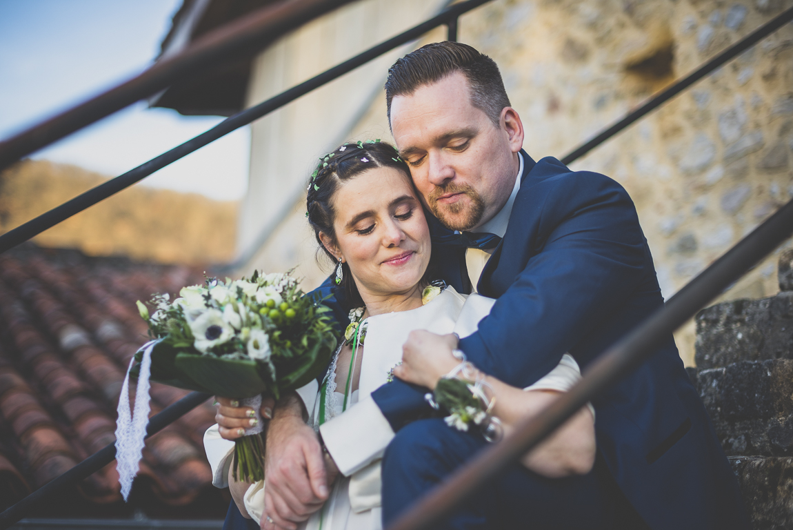 Winter Wedding Photography - portrait of bride and groom sitting down on steps - Wedding Photographer