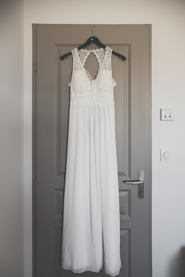 Winter Wedding Photography - bride's dress hung against door - Wedding Photographer