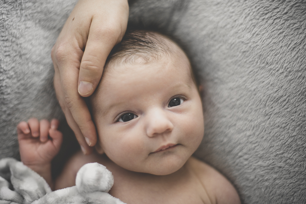 Séance nouveau-né à domicile Saint-Gaudens - portrait de bébé avec main de maman - Photographe nouveau-né