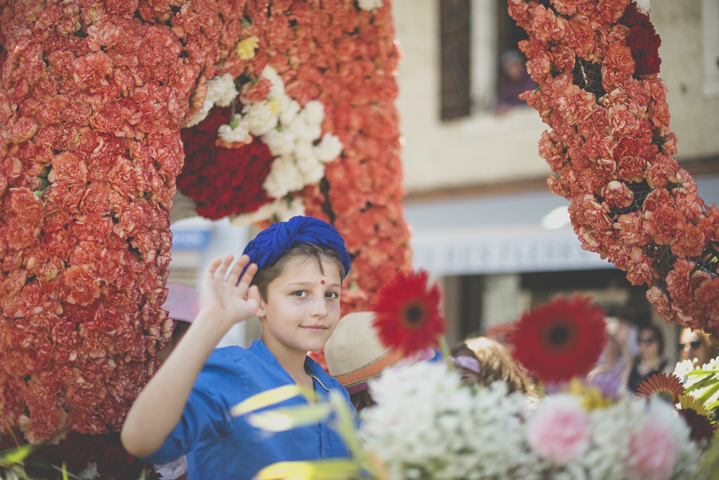 Fete des fleurs Cazeres 2018 - enfant salut de la main dans char fleuri - Photographe Haute-Garonne