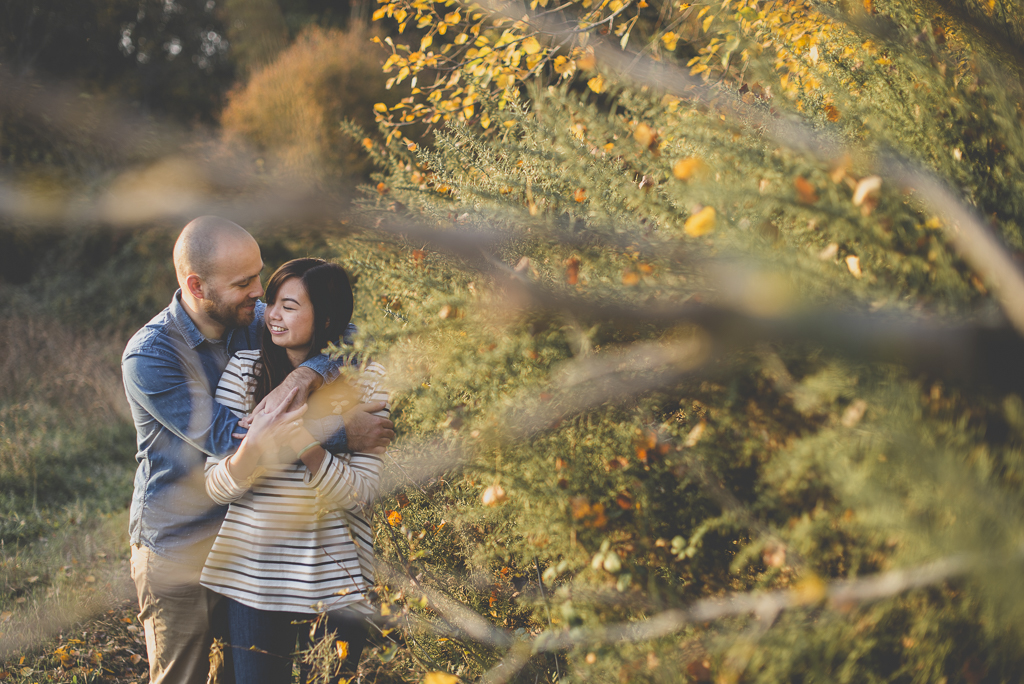 Séance photo en amoureux en exterieur - couple entrelacé derriere branches - Photographe couple Toulouse