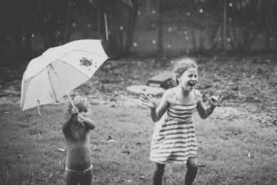 Family photo session at home - two girls playing under the rain - Family Photographer